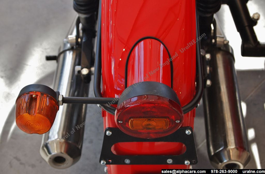 This photo shows the Retro Rear Motorcycle Light Adapter, as part of the complete Retro Rear Light Kit (including gasket and light assembly).