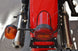 This photo shows the Retro Rear Motorcycle Light Adapter, as part of the complete Retro Rear Light Kit (including gasket and light assembly).